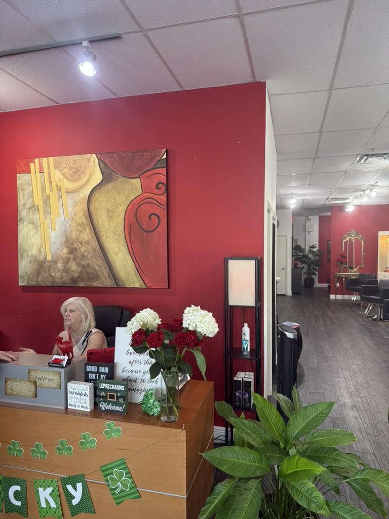 Denise at the reception desk with fresh flowers